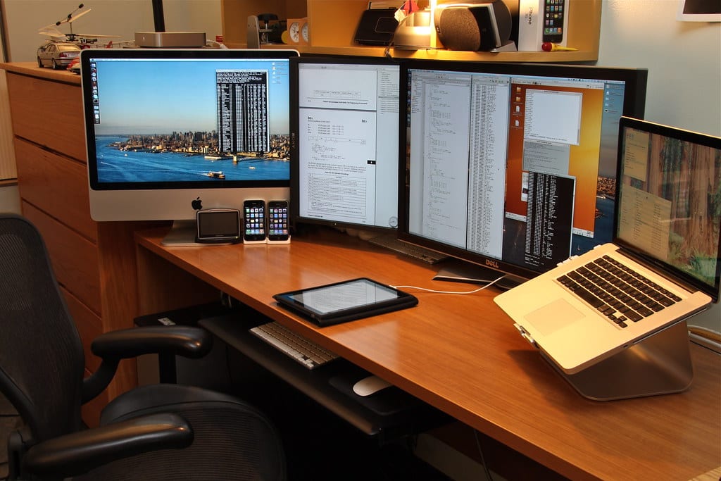 A bright white desk setup with a light desk mat and hidden cables