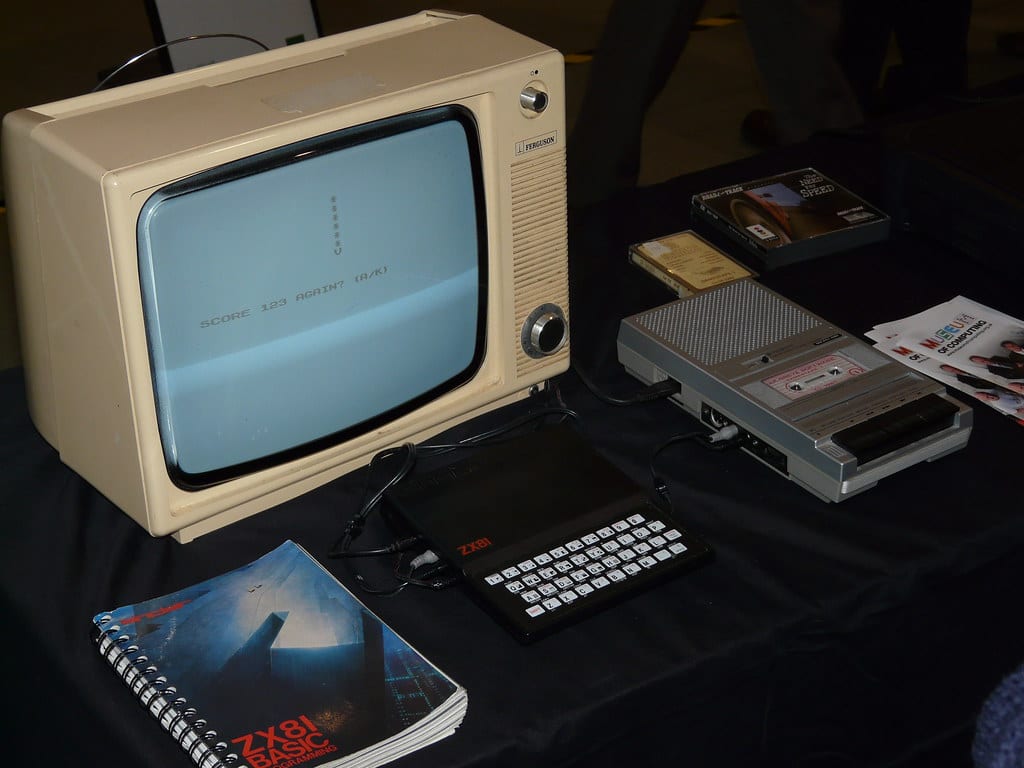 A single monitor floating on an arm above a clear desk with the base freed up