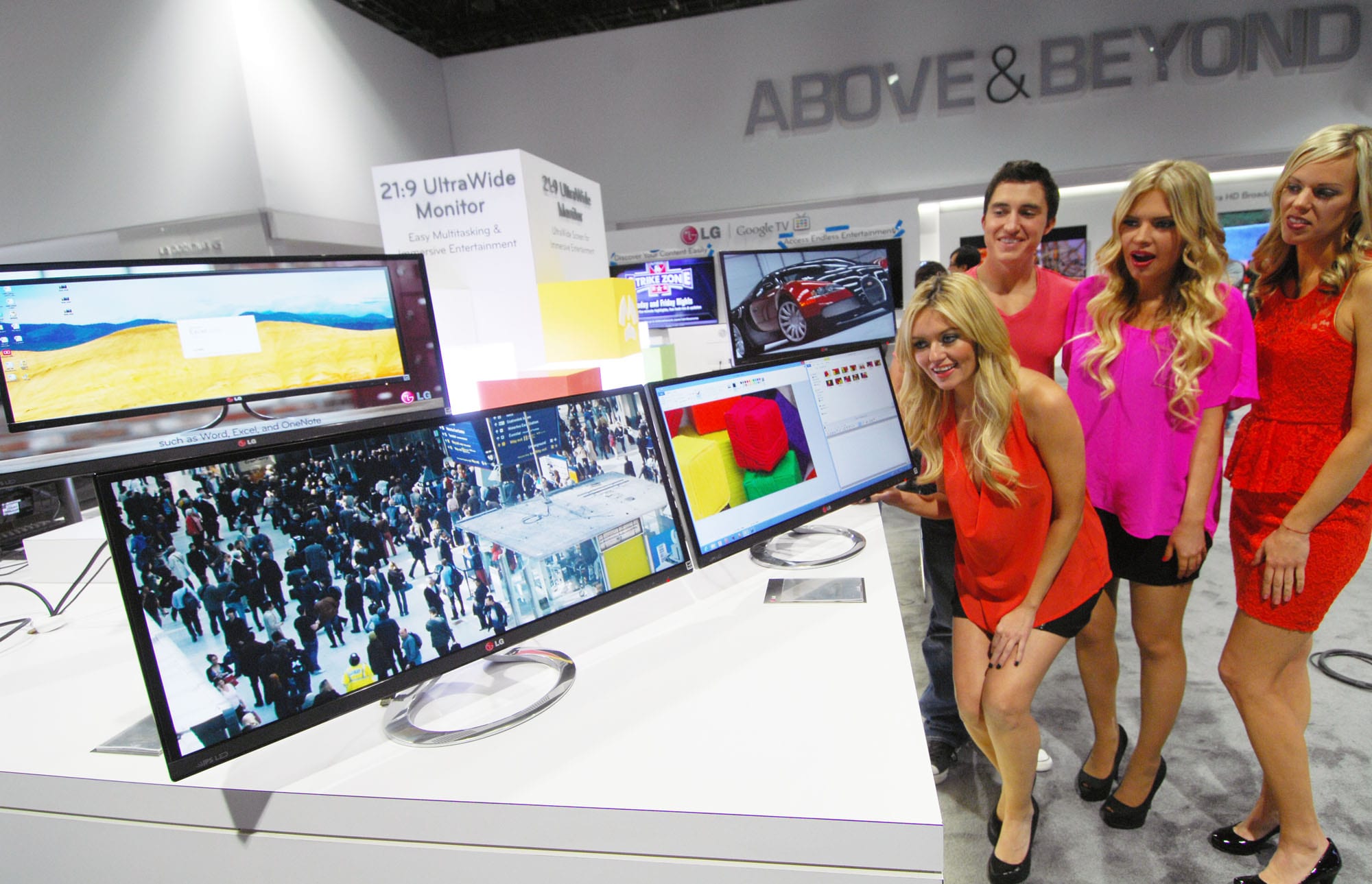An ultrawide monitor with a small portrait monitor on an arm to its side